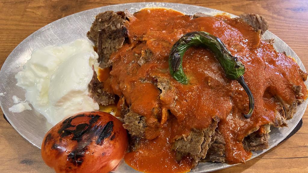 Iskender Kebab · Lamb gyro layer on homemade bread croutons, topped with garlic yogurt sauce. Served with special tomato sauce. Doesn't come with rice and salad.