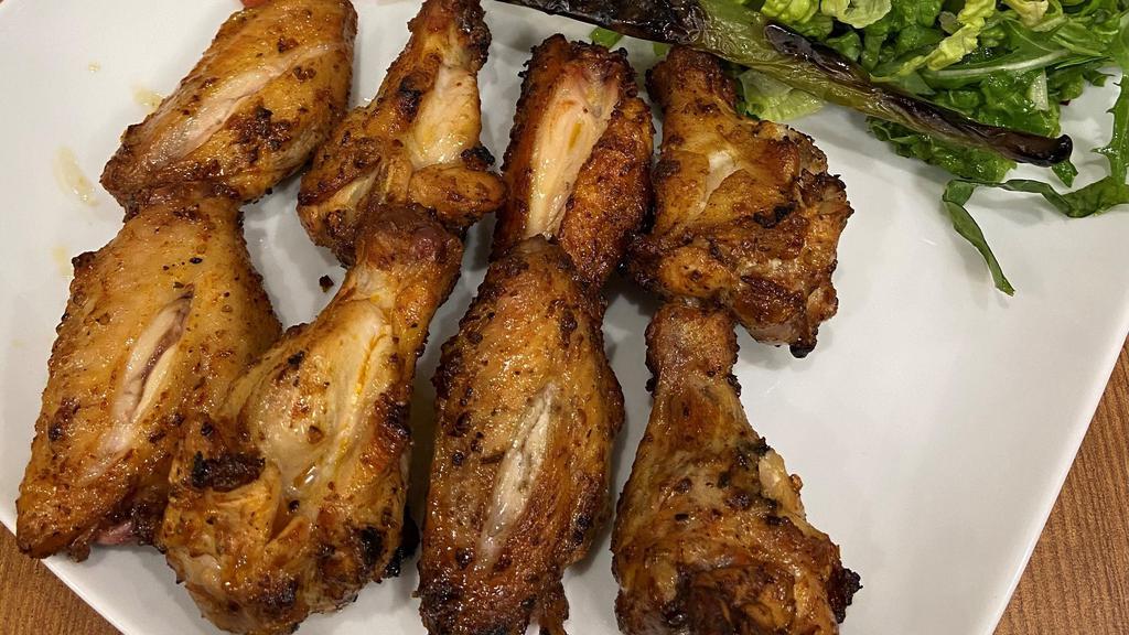 Chicken Wings · Marinated chicken wings grilled to your taste.