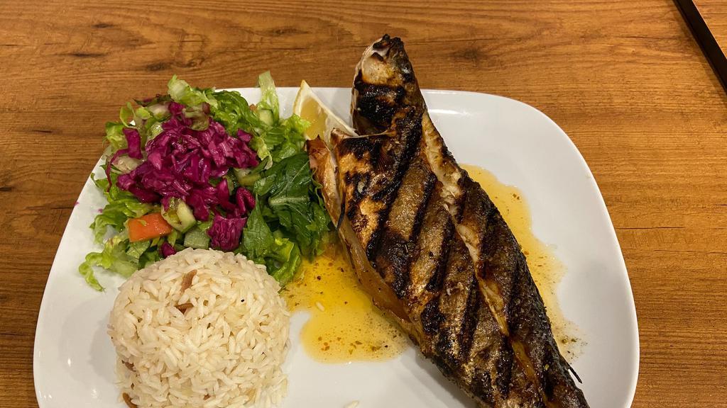 Chargrilled Branzini · Exotic flaky, white sweet meat. Ordered as a whole. Served with salad and rice.