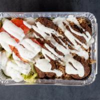 Falafel Over Rice · Served with salad and choice of sauce.