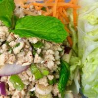 Larb Chicken Salad · Spicy. Minced chicken seasoned with lime juice, chili, rice powder, cilantro, and fresh mint...