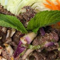 Beef Salad · Spicy. Slices of grilled beef tossed in spicy lime juice dressing, red onions, scallions, ri...