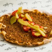 Lahm Bi Ajin · Ground beef, tomatoes, and onion baked on our crispy flatbread and served with fresh lemon w...