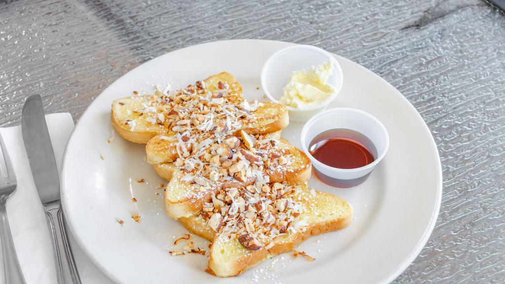 Coconut Almond  · 3 Delicious slices of French toast with roasted coconut and almonds sprinkled on top and powdered sugar with  syrup and butter yummy !