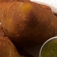 Samosa Chat · Vegetable samosa with chicken peas and sauces.