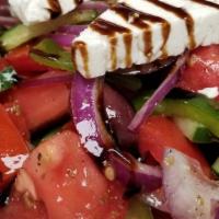 Greek Salad · tomatoes,  onions, Kalamata olives, cucumbers, green peppers, feta, and olive oil-red vinegar