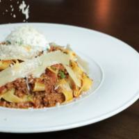 Fettuccini Bolognese · fettuccini served with a slow simmered angus beef ragu and topped with parmigiana