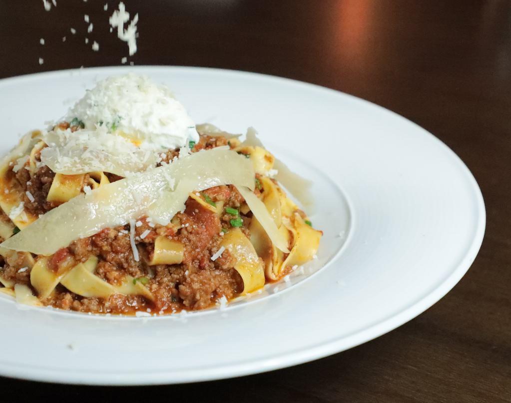 Fettuccini Bolognese · fettuccini served with a slow simmered angus beef ragu and topped with parmigiana