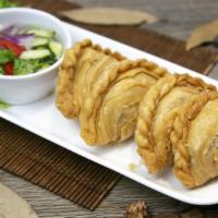 Chicken Curry Puff · Crispy pastry pouch of chicken, potato and onion. Served with ajad salad (cucumber, shallot,...