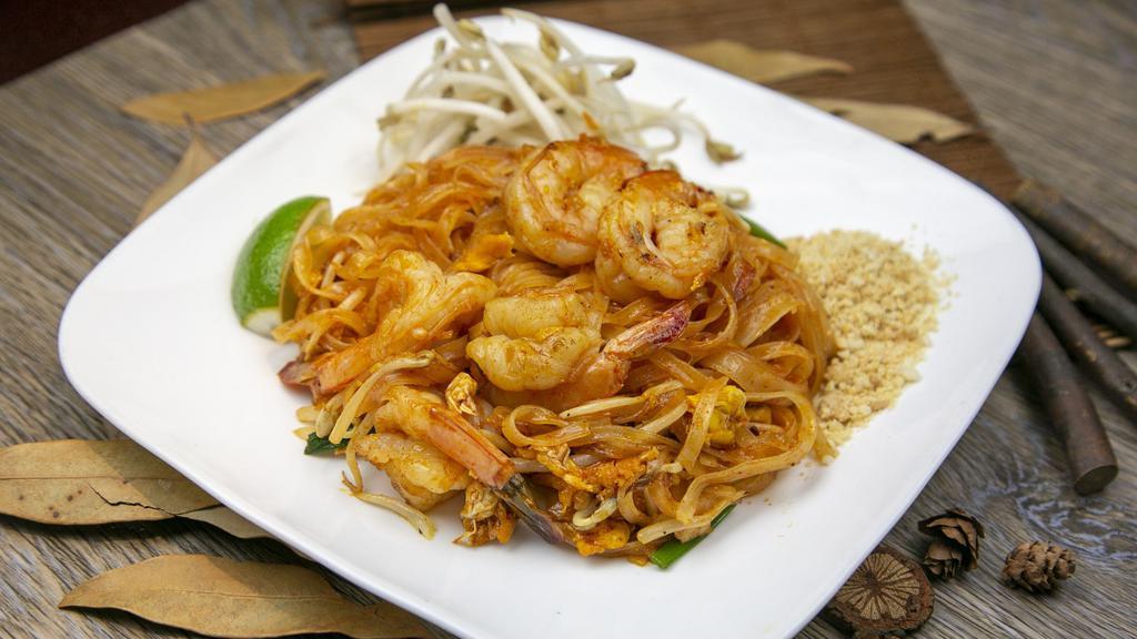 Pad Thai · Sautéed rice noodles in a lime/tamarind sauce with egg, bean sprouts, scallion, crushed peanuts, and your choice of meat or tofu.