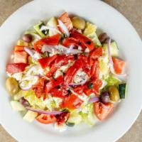 Greek Salad · iceberg lettuce topped with red onions, black olives, tomatoes, cucumbers, roasted red peppe...