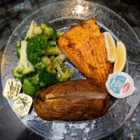 Grilled Salmon · Served with lemon butter sauce, baked potato, and broccoli.