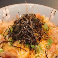 Chicken · Chicken and egg with stir-fried onions over rice, negi, spicy powder, and nori flakes.