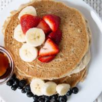 Gluten-Free & Vegan Pancakes · Two gluten free pancakes made with almond milk, and banana, topped with fresh fruit.