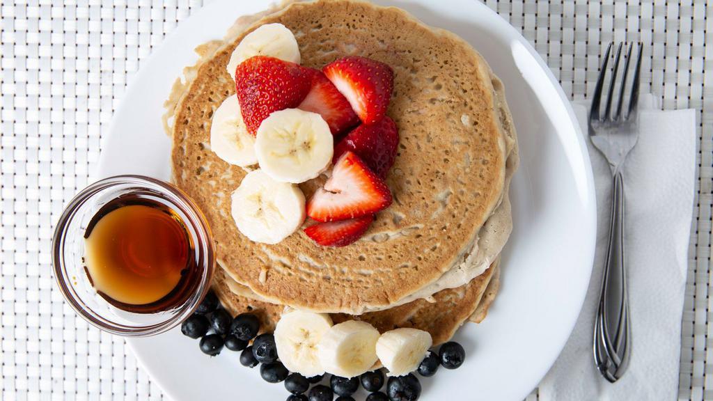 Gluten-Free & Vegan Pancakes · Two gluten free pancakes made with almond milk, and banana, topped with fresh fruit.