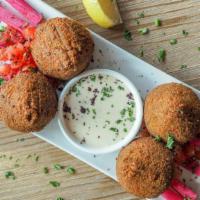 Falafel · Vegetarian. Made with chickpeas, onions, cumin and parsley. Served with tahini sauce.