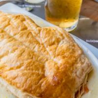 Chicken Pot Pie · Piping hot chicken, peas, carrots, onions stewed together in our home made sauce and capped ...