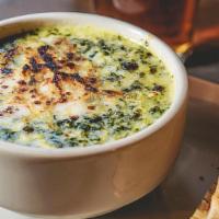 Artichoke & Spinach Dip · With toasted pita bread.