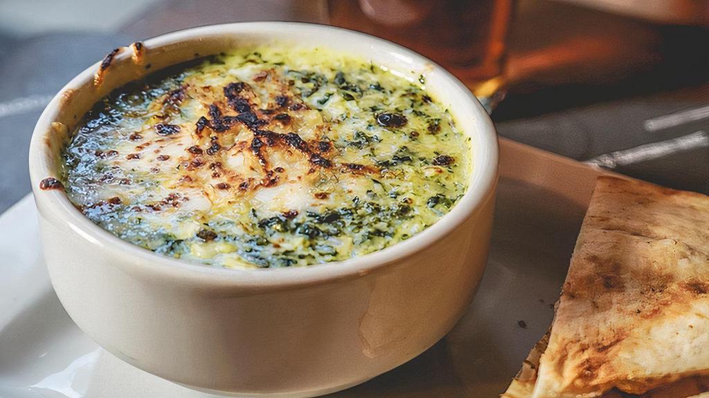 Artichoke & Spinach Dip · With toasted pita bread.