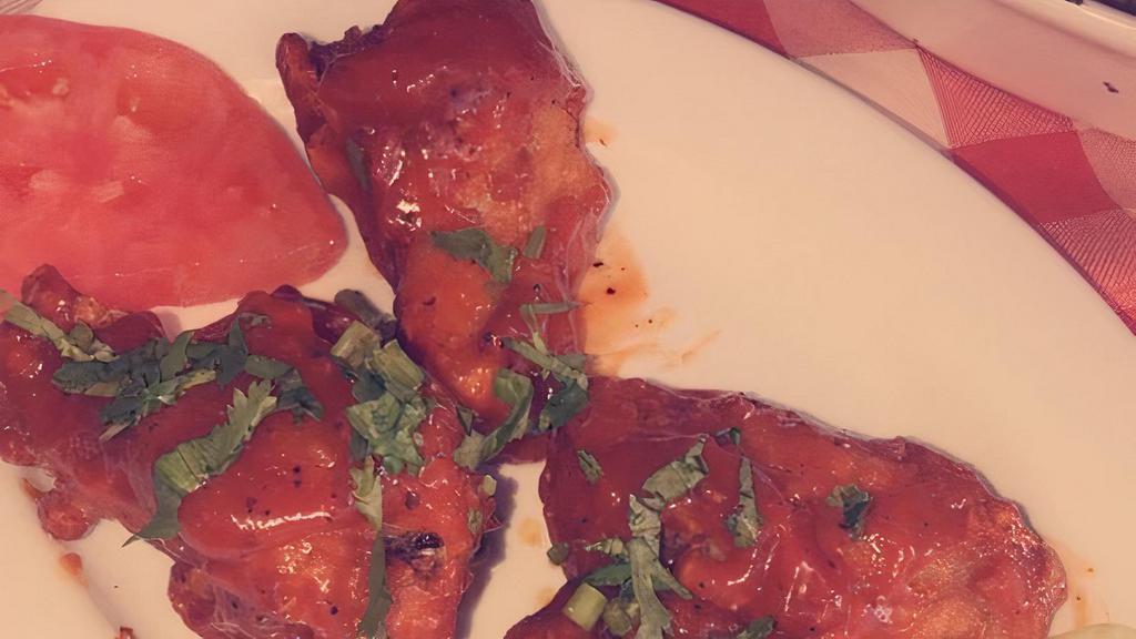 Masala Wings · Chicken wings with a side of mild or vindaloo (spicy) sauce.