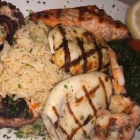 Grilled Seafood Entree · Salmon, calamari, shrimp and octopus served with rice and sauteed spinach.
