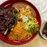 Carne Asada · Thin sliced grilled steak seasoned to perfection served with Mexican rice, refried beans and...