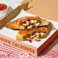 The Heights Calzone · Calzone with juicy pesto chicken, tomato, melted parmesan and mozzarella, and a side of mari...