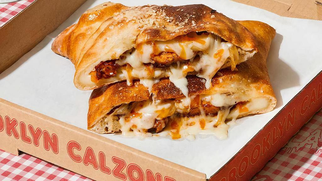The Barclays Calzone · Calzone with sausage, pepperoni, bacon, ham, melted mozzarella, and a side of marinara.