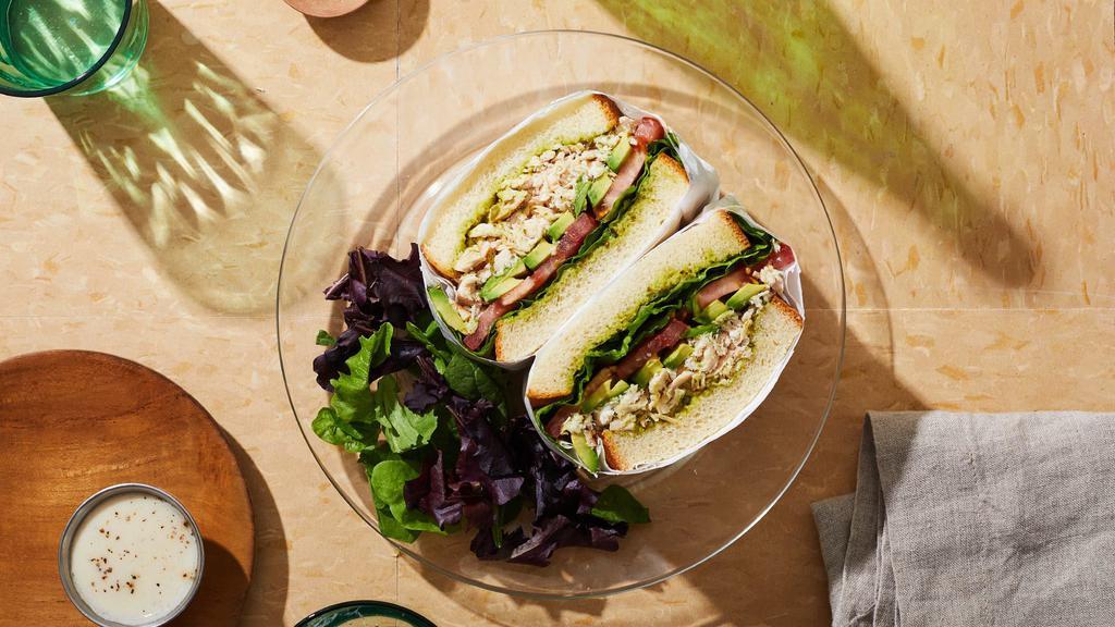 House Chicken Pesto Sandwich · Shredded chicken with pesto mayo, avocado, tomato, and lettuce on a seeded roll.