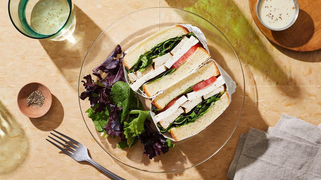 Chicken Caprese Sandwich · Grilled chicken breast with mozzarella cheese, basil, heirloom tomato, arugula, balsamic glaze, and olive oil on a seeded roll.