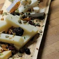 International Cheeseboard · Chef Paul's selection of artisanal cheses with honey, dried fruits, and nuts.