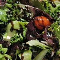 Insalata Tre Colore · Mixed baby field greens tossed with tomatoes, onions, kalamata olives, fresh mozzarella, and...
