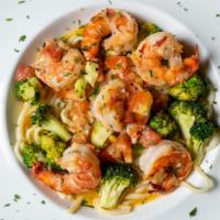 Shrimp Scampi Verdi · Sautéed shrimp with broccoli and diced tomatoes in a garlic lemon white wine sauce, over lin...