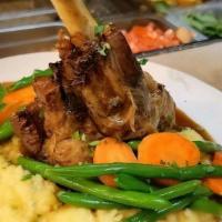 Pork Chop · Grilled 16 oz. French cut pork chop glazed with our maple bourbon sauce and served with roas...