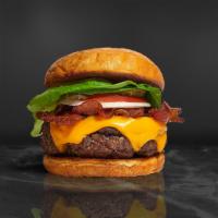 Bacon Burger · Half pound beef patty topped with melted cheese, layers of crispy bacon, lettuce, tomato, on...
