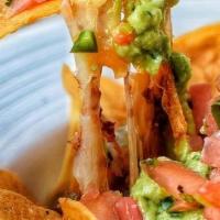 Nachos Grande. · Chili con carne, shredded cheese, pico de gallo, sour cream, guacamole.
