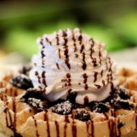 Oreo Waffle · Oreo baked waffle, vanilla cream, chocolate syrup, whipped cream.