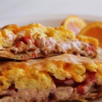 Baja Breakfast · Homemade baja sauce, scrambled eggs, bacon, roasted red peppers, cheddar cheese.