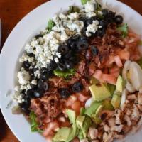 Cobb Salad · Grilled chicken, avocado, blue cheese, bacon, olives, eggs, tomatoes, field greens, sherry-s...