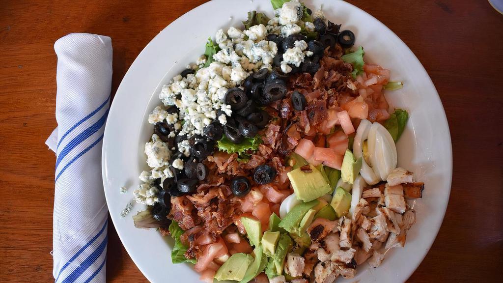 Cobb Salad · Grilled chicken, avocado, blue cheese, bacon, olives, eggs, tomatoes, field greens, sherry-shallot vinaigrette.
