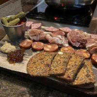 Charcuterie Board · Our selection of premium cured meats, artisan crackers and accompaniments.