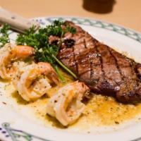Ny Sirloin 12Oz & Shrimp Scampi · grilled and served with sautéed jumbo shrimp in garlic wine sauce. With Potato and Mixed Veg...