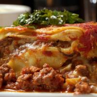Lasagna Malfatta · House made pasta, creamy ricotta, mozzarella, bolognese bechamel meat sauce.