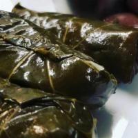 Dolmadakia · Grape leaves stuffed with rice and herbs. Served cold.