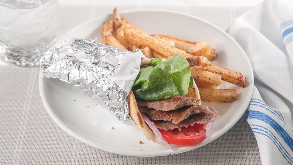 Lamb Gyro · Seasoned ground lamb, slowly roasted, and sliced to order from our custom verticle rotisserie. Tzatziki, tomatoes, red onions, Romain, and wrapped in pita. Served with a side.