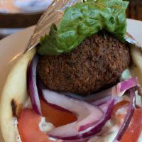 Falafel · Chickpea fritters, lettuce, red onions, tomatoes, tzatziki, and wrapped in pita Served with ...