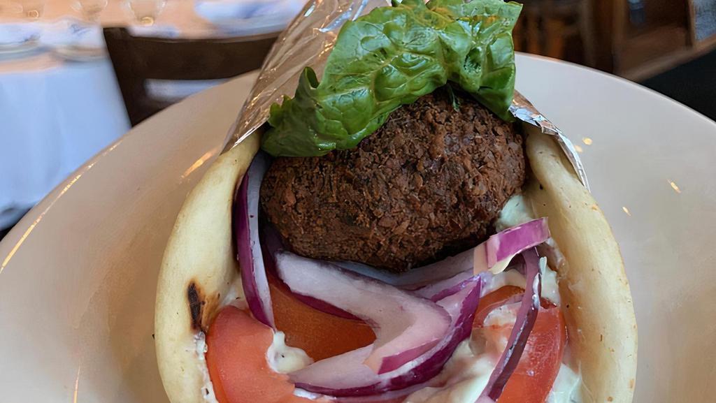 Falafel · Chickpea fritters, lettuce, red onions, tomatoes, tzatziki, and wrapped in pita Served with a side.