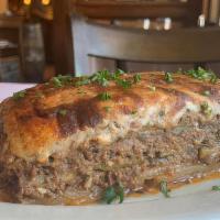 Moussaka · Layers of baked eggplant, zucchini, potatoes, meat sauce, and bechamel.
