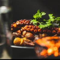Oven Charred Mediterranean Octopus · Mediterranean Spice Glaze, pea puree, crispy guanciale, fried potato, bravas aioli