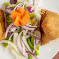 Vegetable Samosa · Two pieces. Mildly spiced triangle vegetable patties.